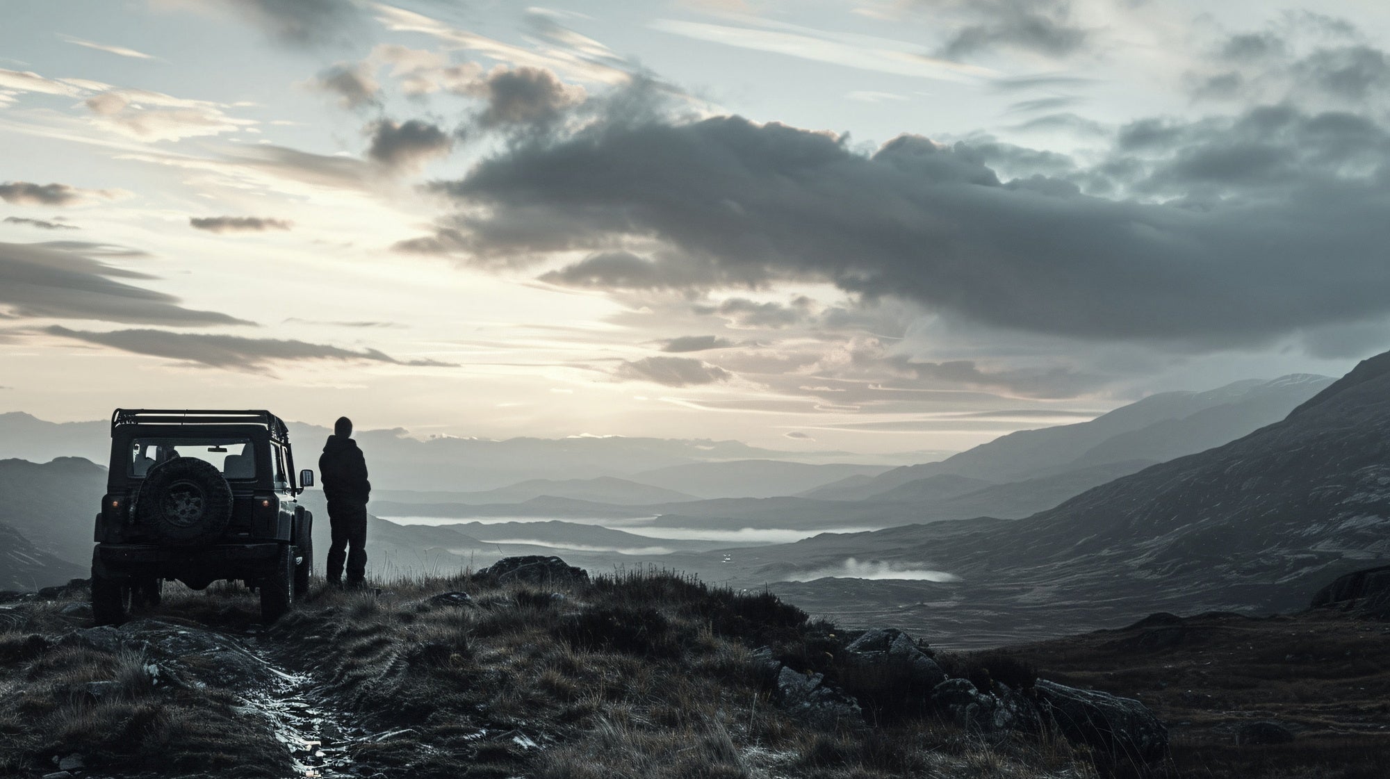 Man on mountains with car